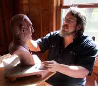 David, working on a portrait bust.